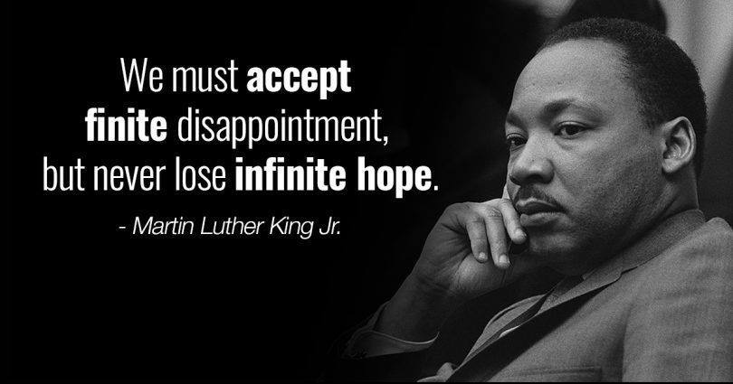 Photo of Rev. Dr. Martin Luther King Jr. next to his quote "We must accept finite disappointment but never lose infinite hope."