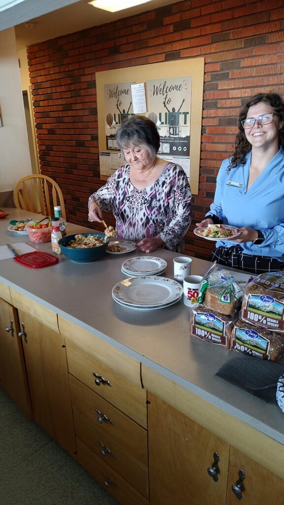 LIFTT Team Members Marilyn Gone and Anya Pulis serve up a Chicken Orzo salad and other healthy goodies during a recent lunch at LIFTT