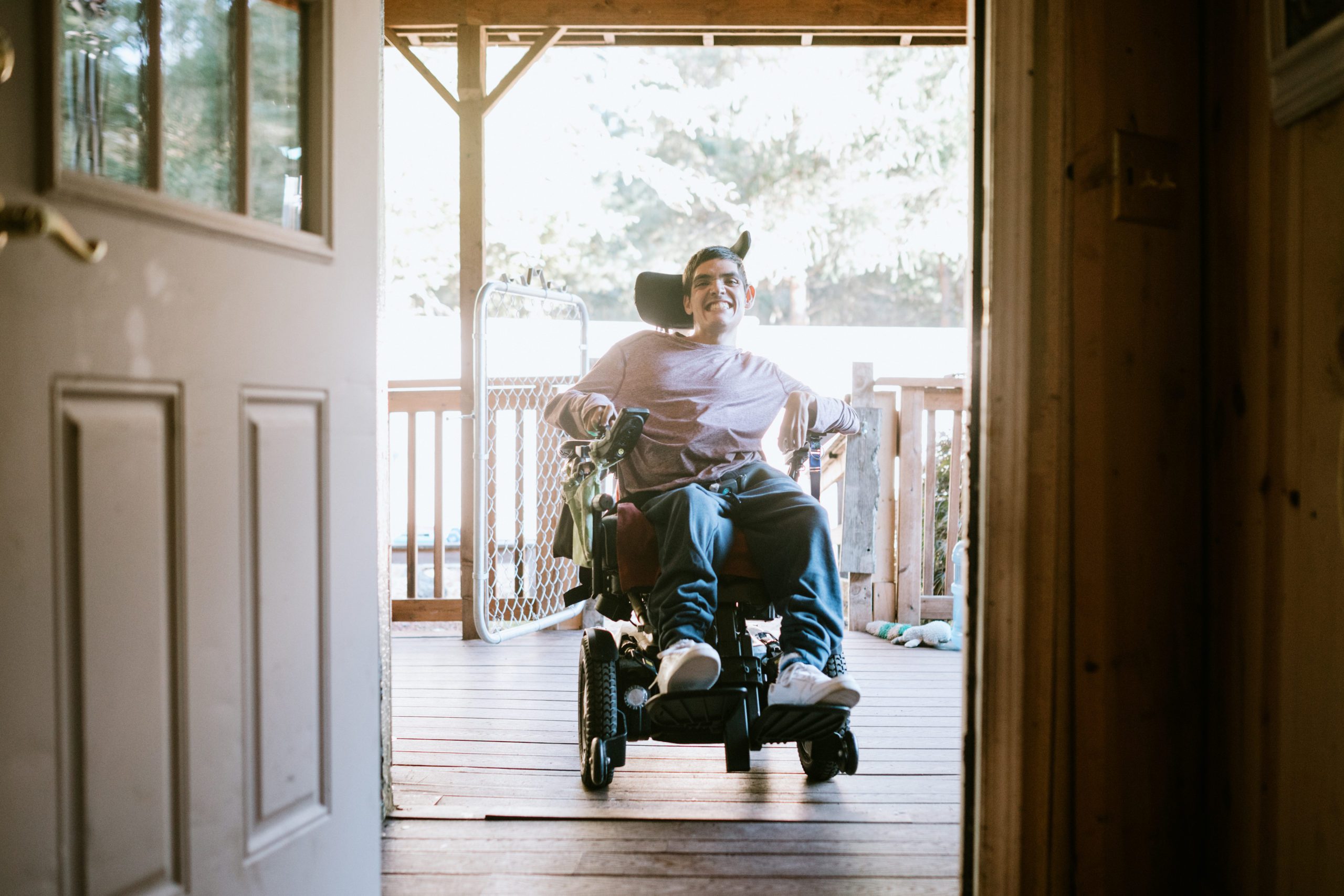 Confident Young Man In Wheelchair At Home Confident Young Man In Wheelchair At Home