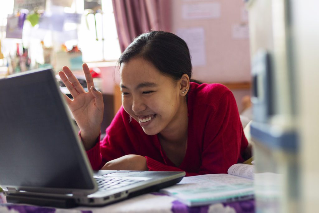 Young girl uses her laptop teleconferencing in the house Young girl uses her laptop teleconferencing in the house.
