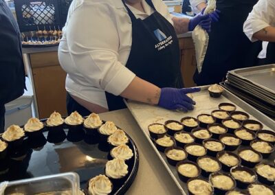 A Passages Culinary Arts Program paricpants prepares a tray of food during the LIFTT grand opening on May 10, 2024