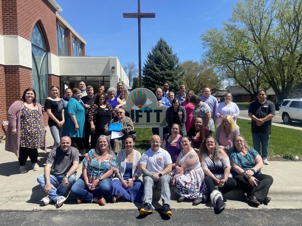 The LIFTT Team poses in front of the main entrance to the new Billings office during the grand opening on May 10, 2024