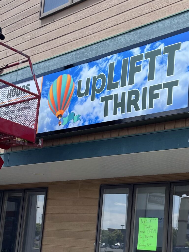 Sign on the front of the upLIFTT Thrift store at 1201 Grand avenue