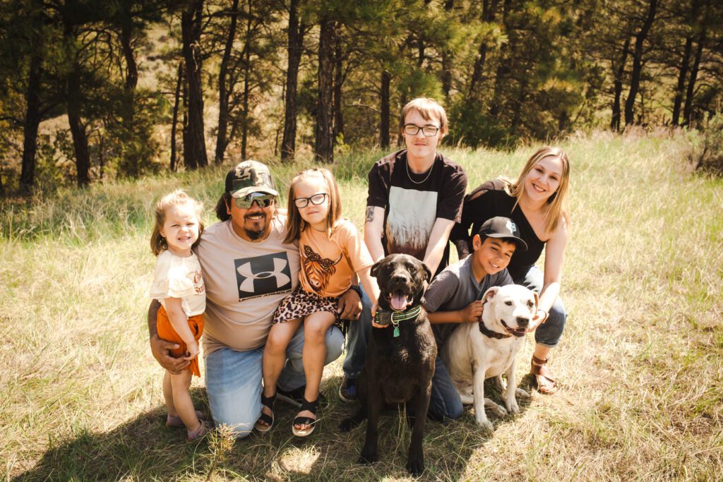 LIFTTT IL Specialist Dalana Smith (at far right) with her family (from left): daughter Zuri, husband Jerry, daughter Breylie, brother Jase, son Bristyn and their two dogs ,Ruger and Bella.