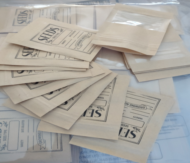 a pile of tan colored resealable seed envelopes