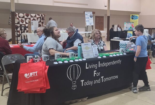 LIFTT Team Members Shilo Mitelstad and Tana Stone visit with a youngster during the Give Local Glendive Event at the Eastern Plains Event Center on May 1, 2025